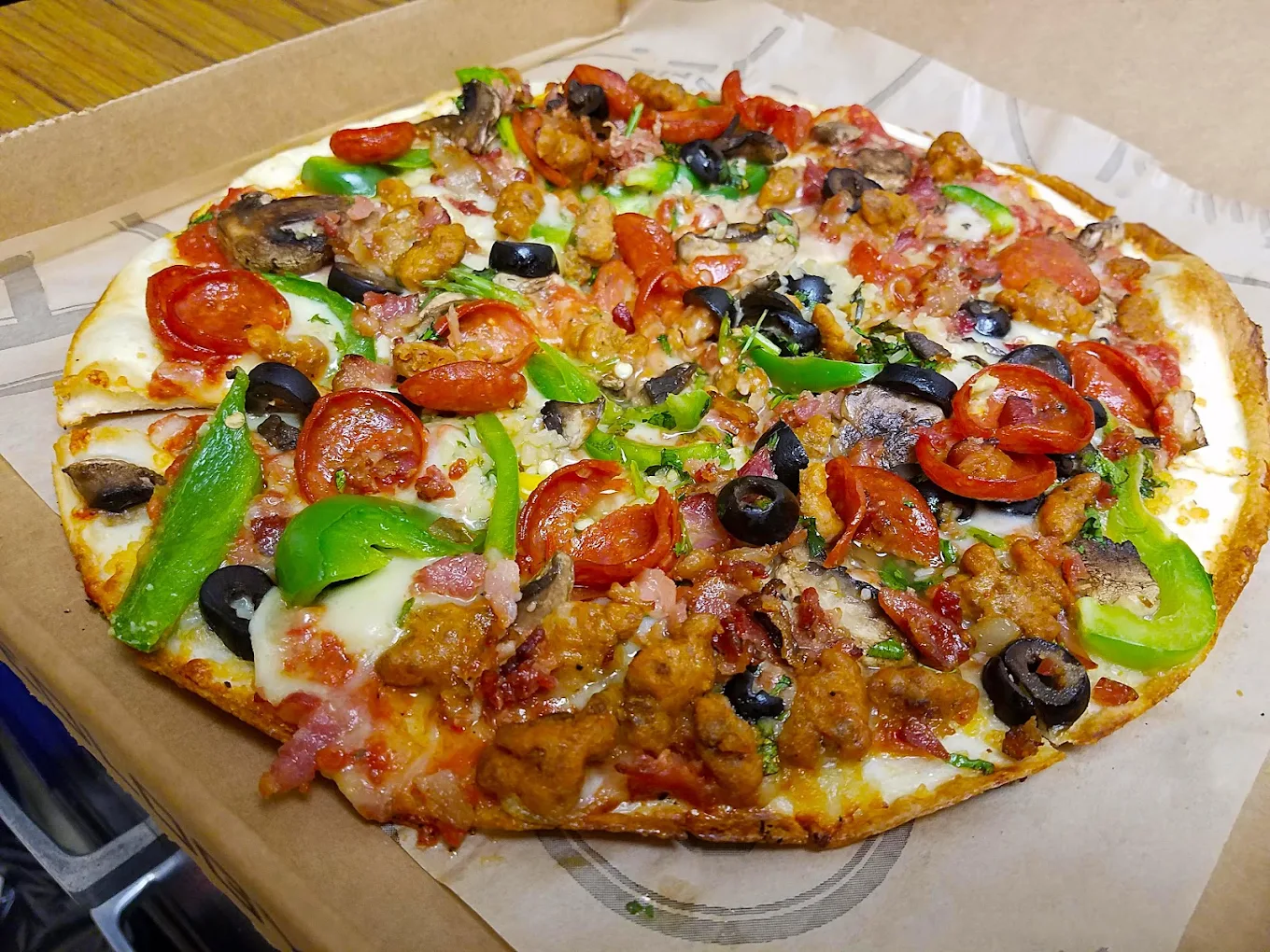 Fire-roasted gluten-free flatbread pizza preparation at Avatara Pizza Calgary — organic and locally sourced ingredients